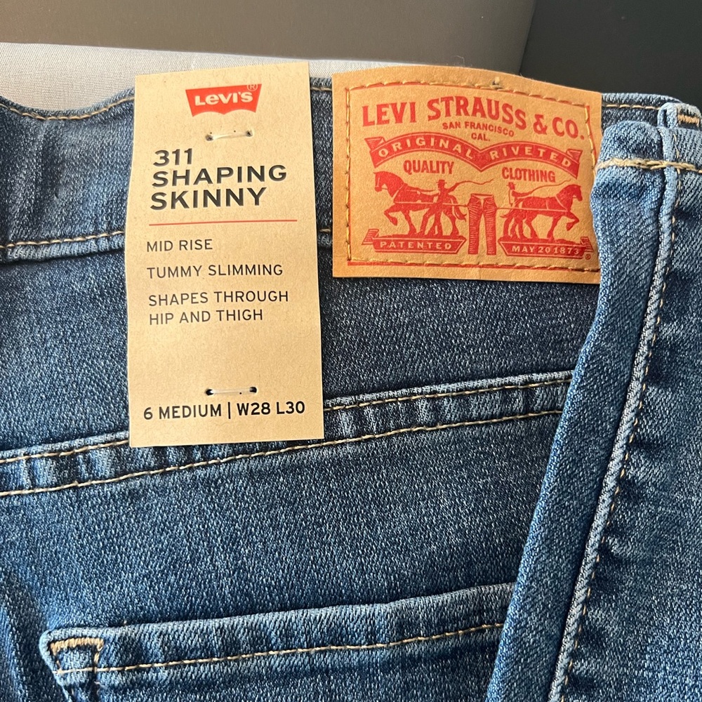 Levi’s Mid Rise 311 Distressed Shaping Jeans